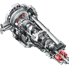 Przekładnia s tronic z widocznymi czerwonymi elementami, ukazująca skomplikowany mechanizm kół zębatych i wałów.