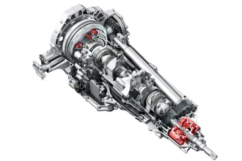Przekładnia s tronic z widocznymi czerwonymi elementami, ukazująca skomplikowany mechanizm kół zębatych i wałów.