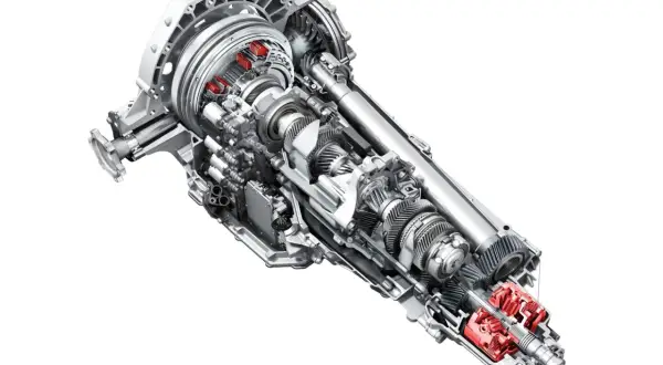 Przekładnia s tronic z widocznymi czerwonymi elementami, ukazująca skomplikowany mechanizm kół zębatych i wałów.