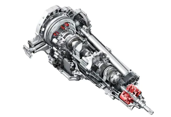 Przekładnia s tronic z widocznymi czerwonymi elementami, ukazująca skomplikowany mechanizm kół zębatych i wałów.